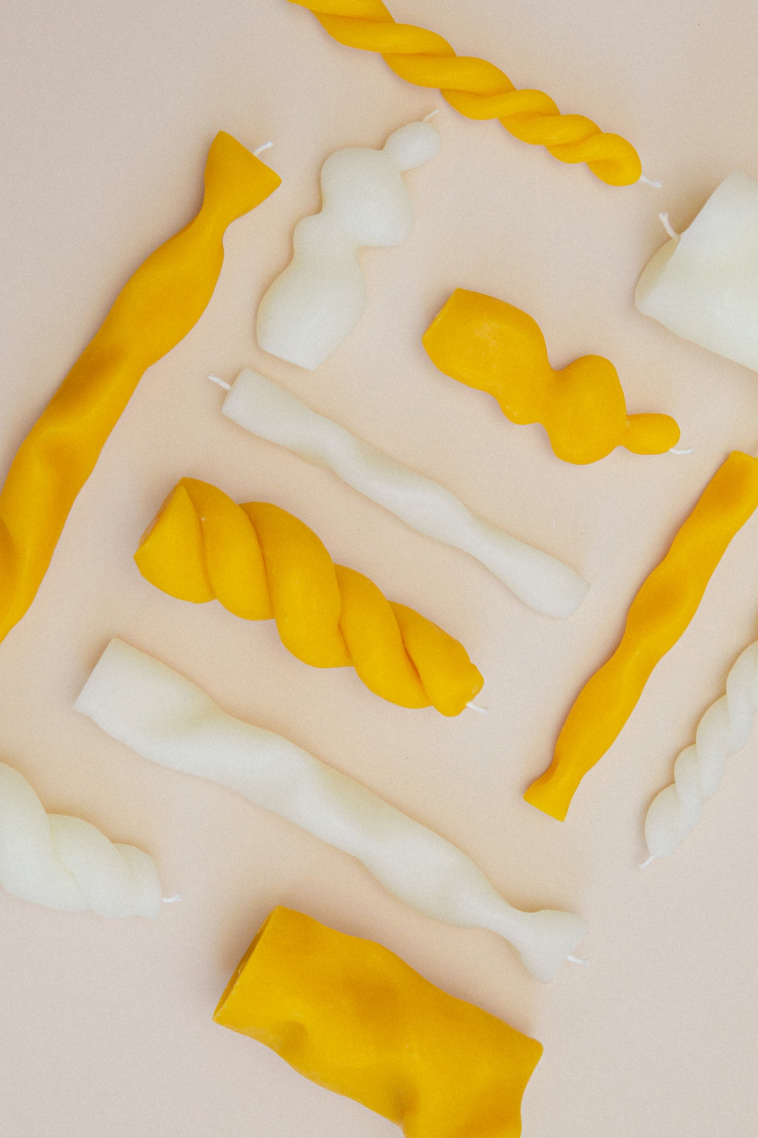 Flatlay of Different Handmade Sculptural Candles Made from White and Yellow Beeswax