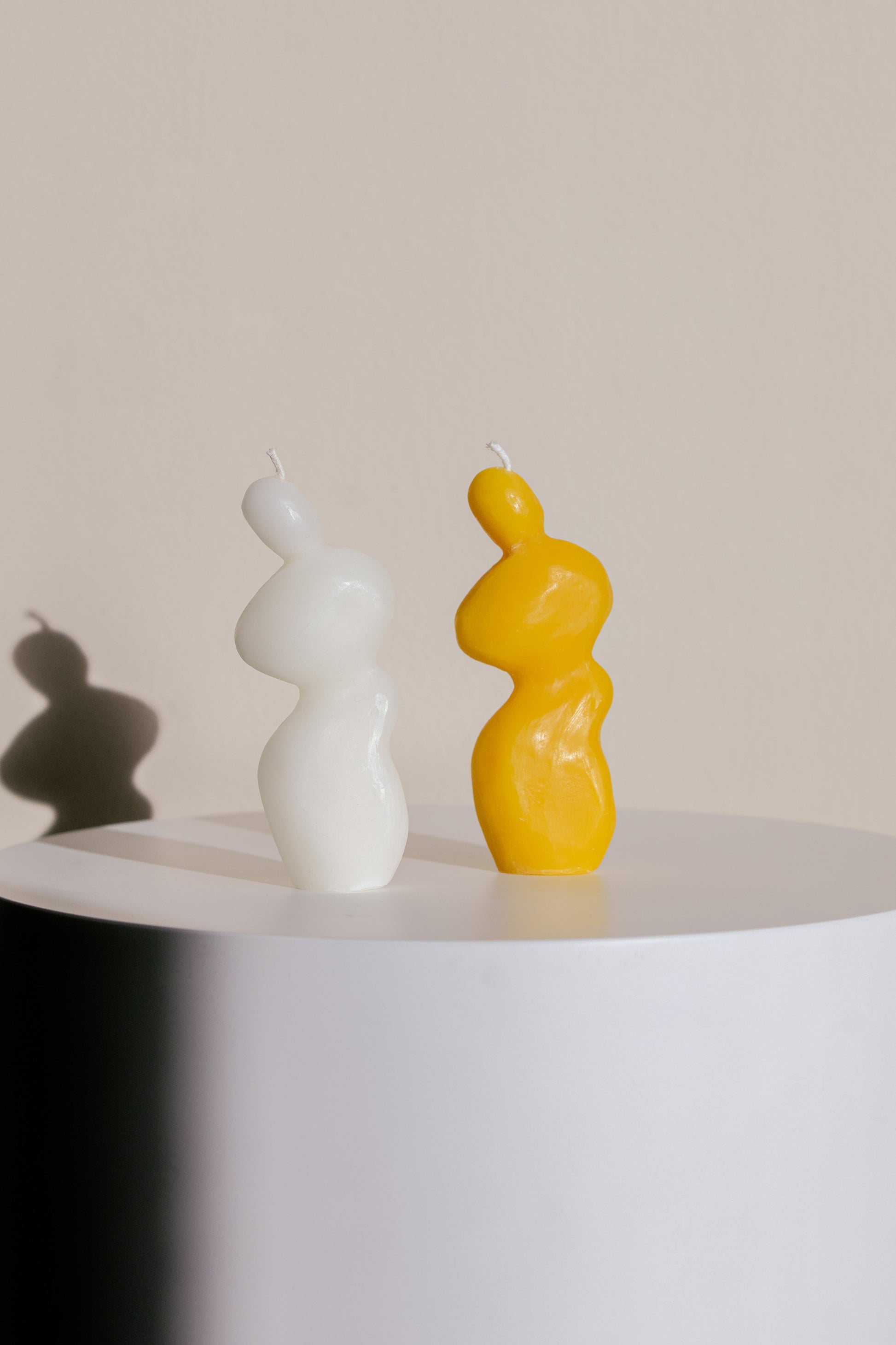 Two Handmade Human Form Sculptural Candles Made from Yellow and White Beeswax